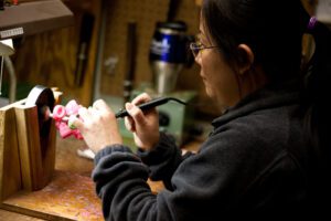 Woman inspects award jewelry at Terryberry's factory