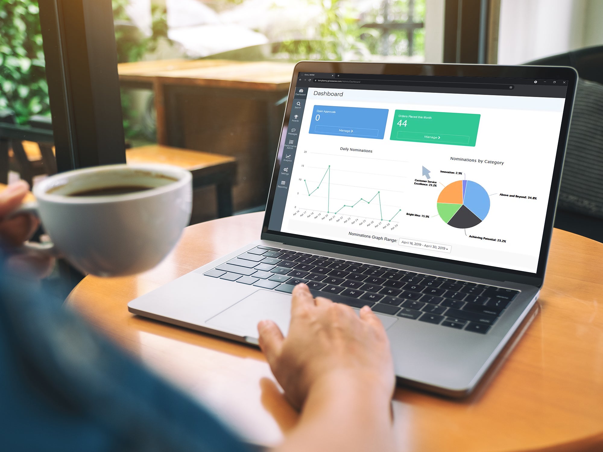 Mockup image of a hand using and touching on laptop touchpad with blank white desktop screen while drinking coffee