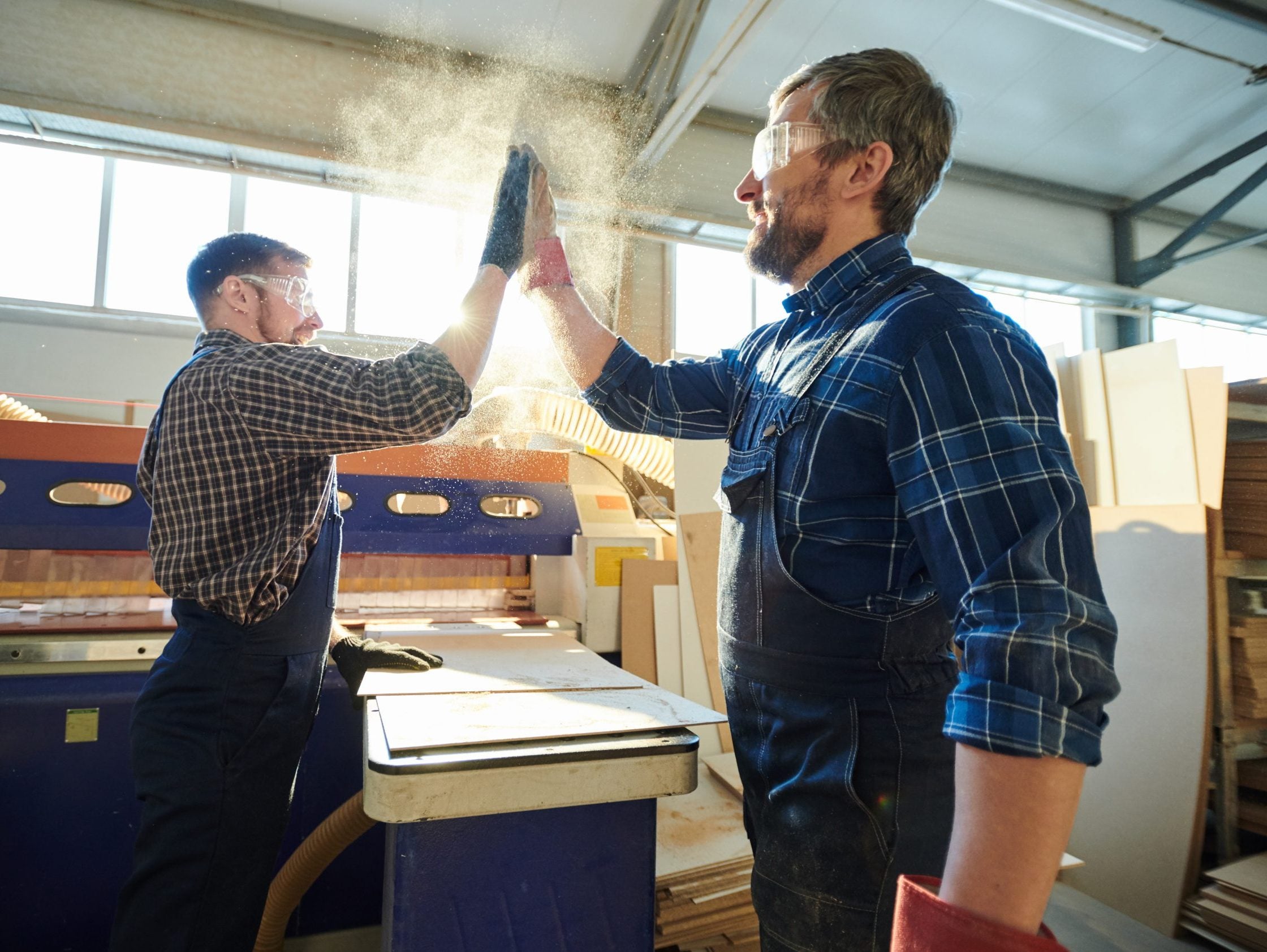 Positive,Satisfied,Bearded,Factory,Workers,Standing,At,Workbench,With,Particleboard