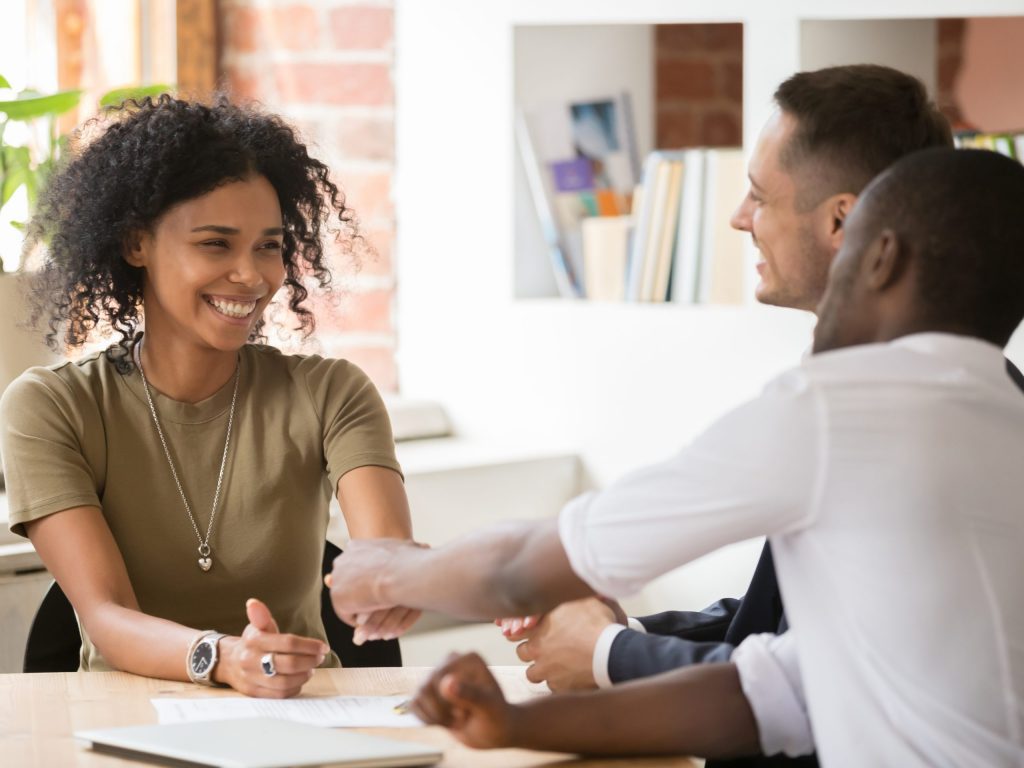 Happy female african vacancy candidate shaking hand of hr recruiting manager congratulating hired applicant with handshake, successful interview winner make good first impression got new job concept