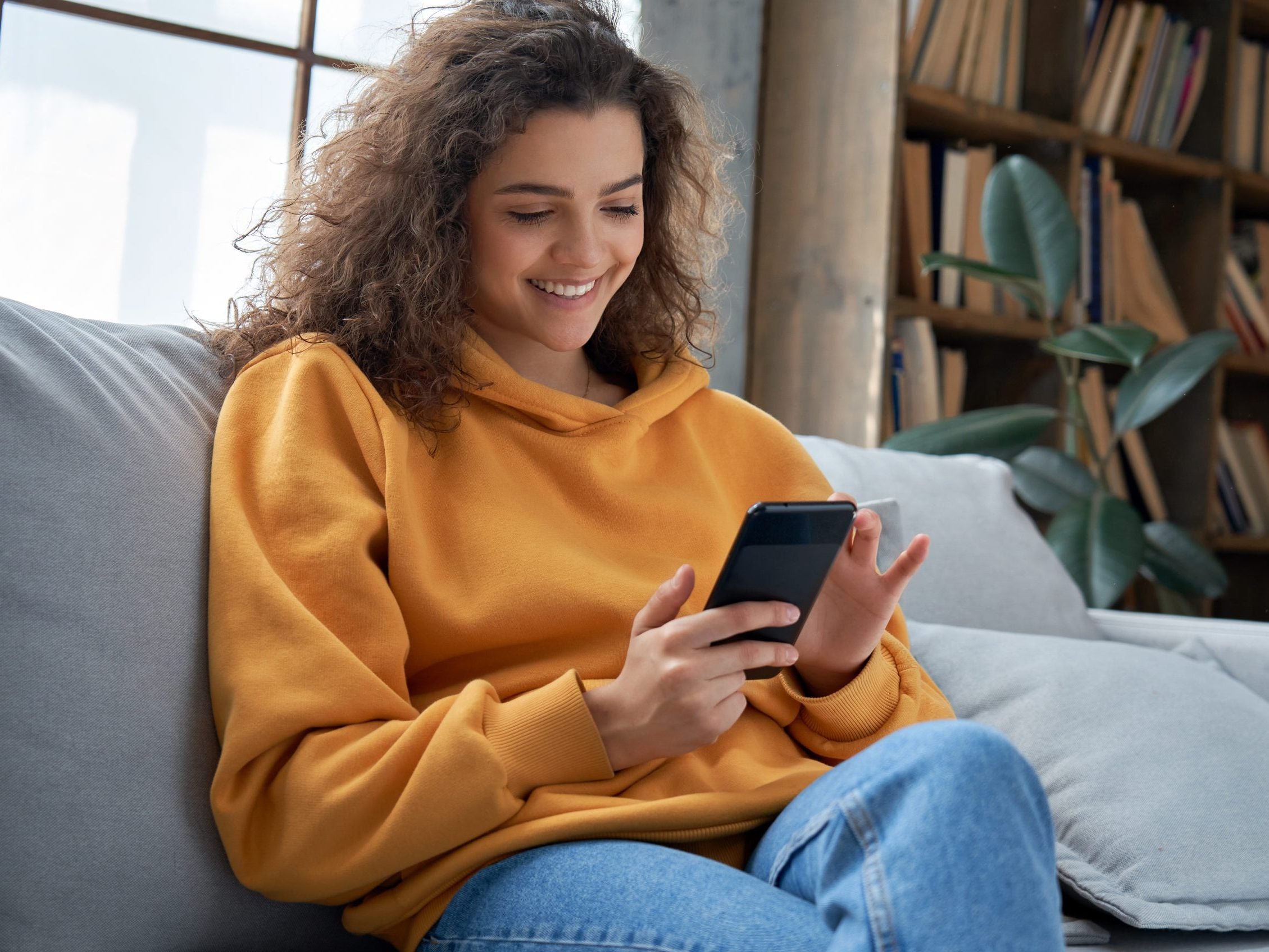 Happy,Millennial,Hispanic,Teen,Girl,Checking,Social,Media,Holding,Smartphone Happy,Millennial,Hispanic,Teen,Girl,Checking,Social,Media,Holding,Smartphone