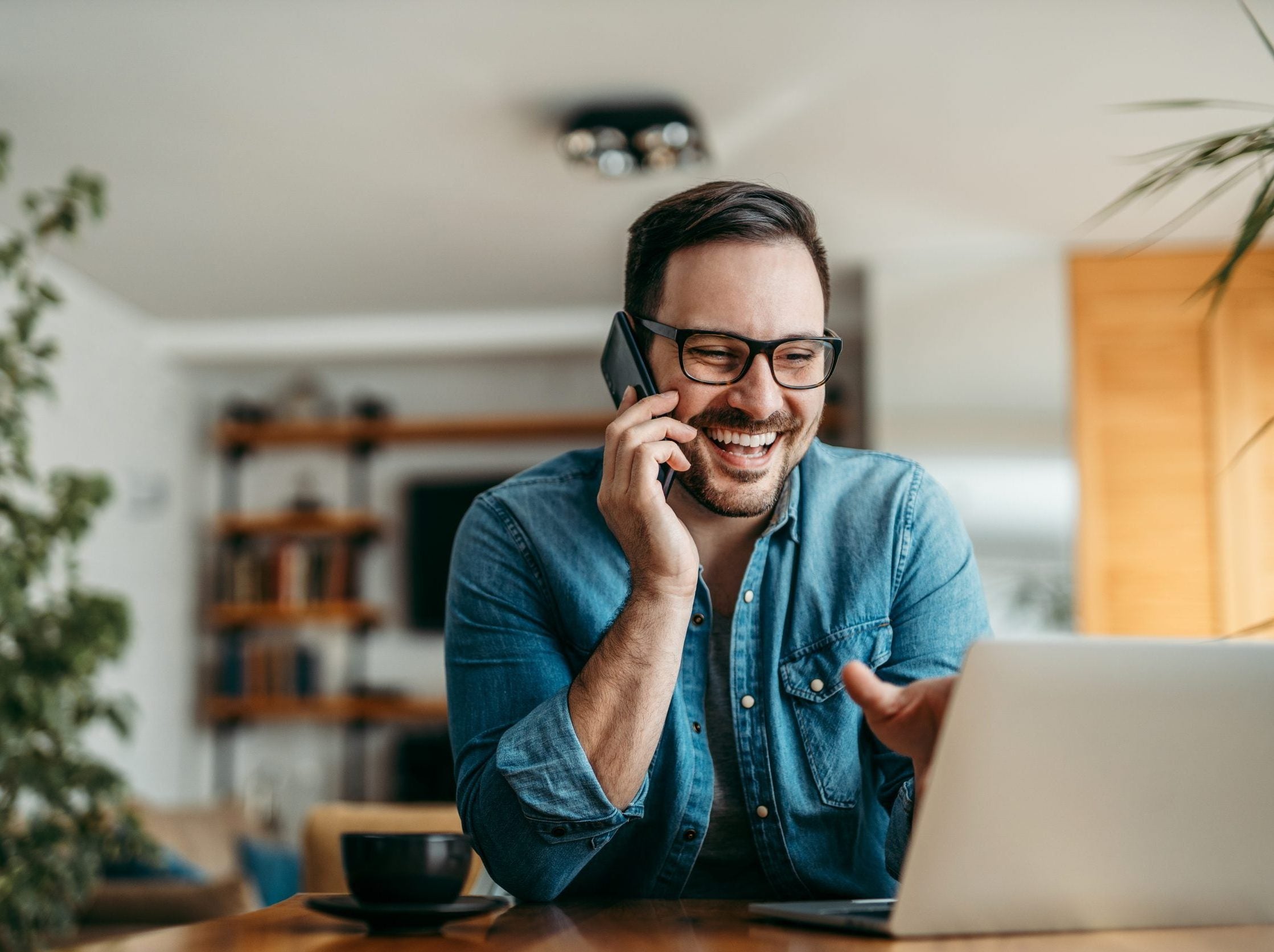 Handsome,Smiling,Man,Talking,On,Smart,Phone,And,Looking,At