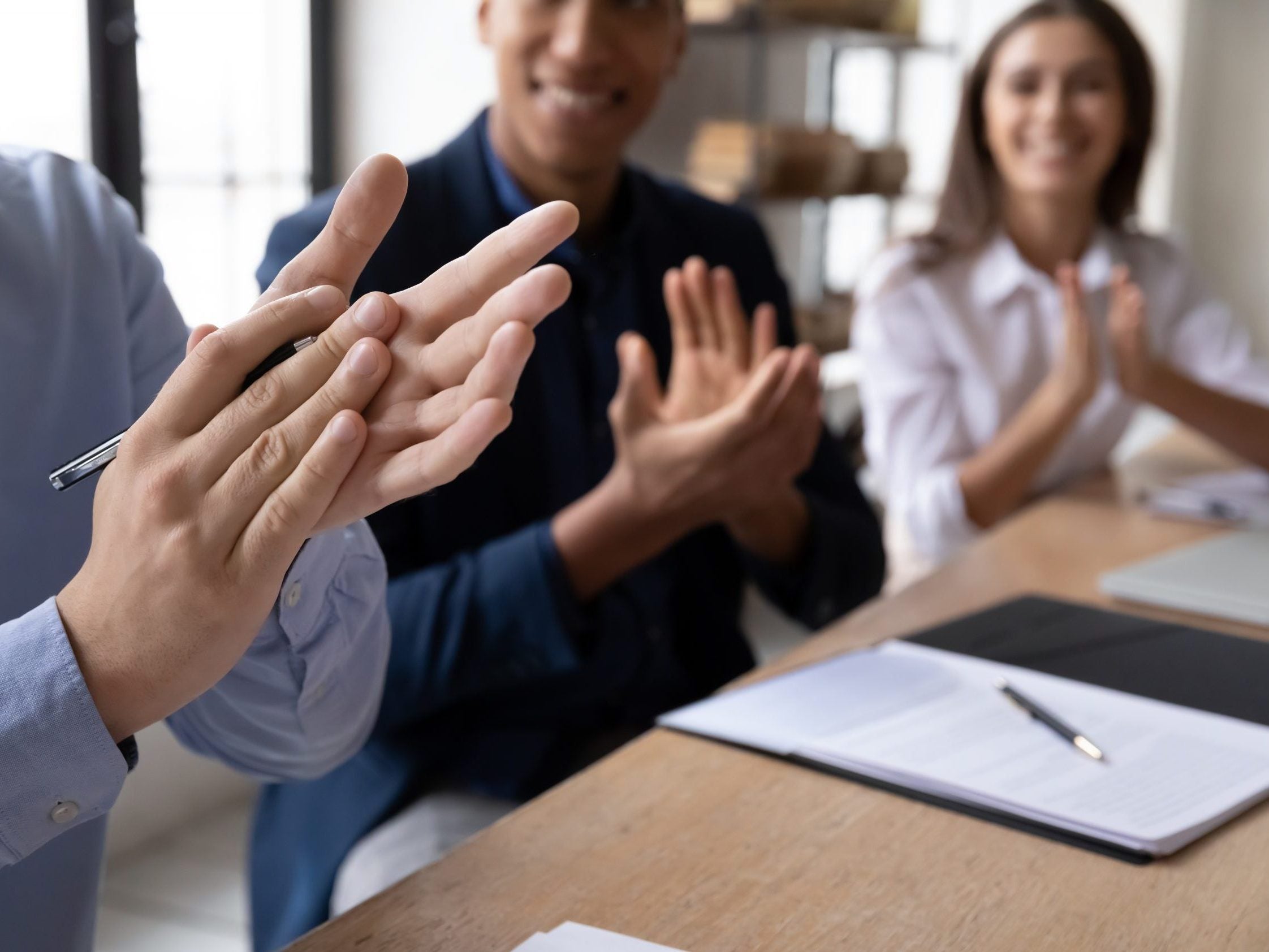 Close,Up,Happy,Diverse,Business,People,Sitting,At,Desk,Applauding Close,Up,Happy,Diverse,Business,People,Sitting,At,Desk,Applauding