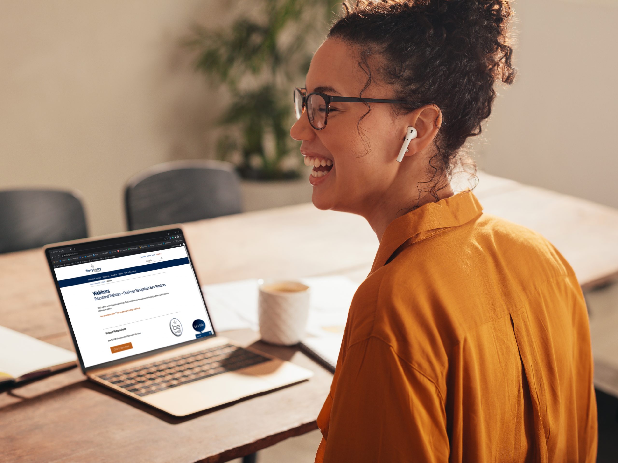 Businesswoman laughing during a video call with team. Female working from home having video conference with colleagues.