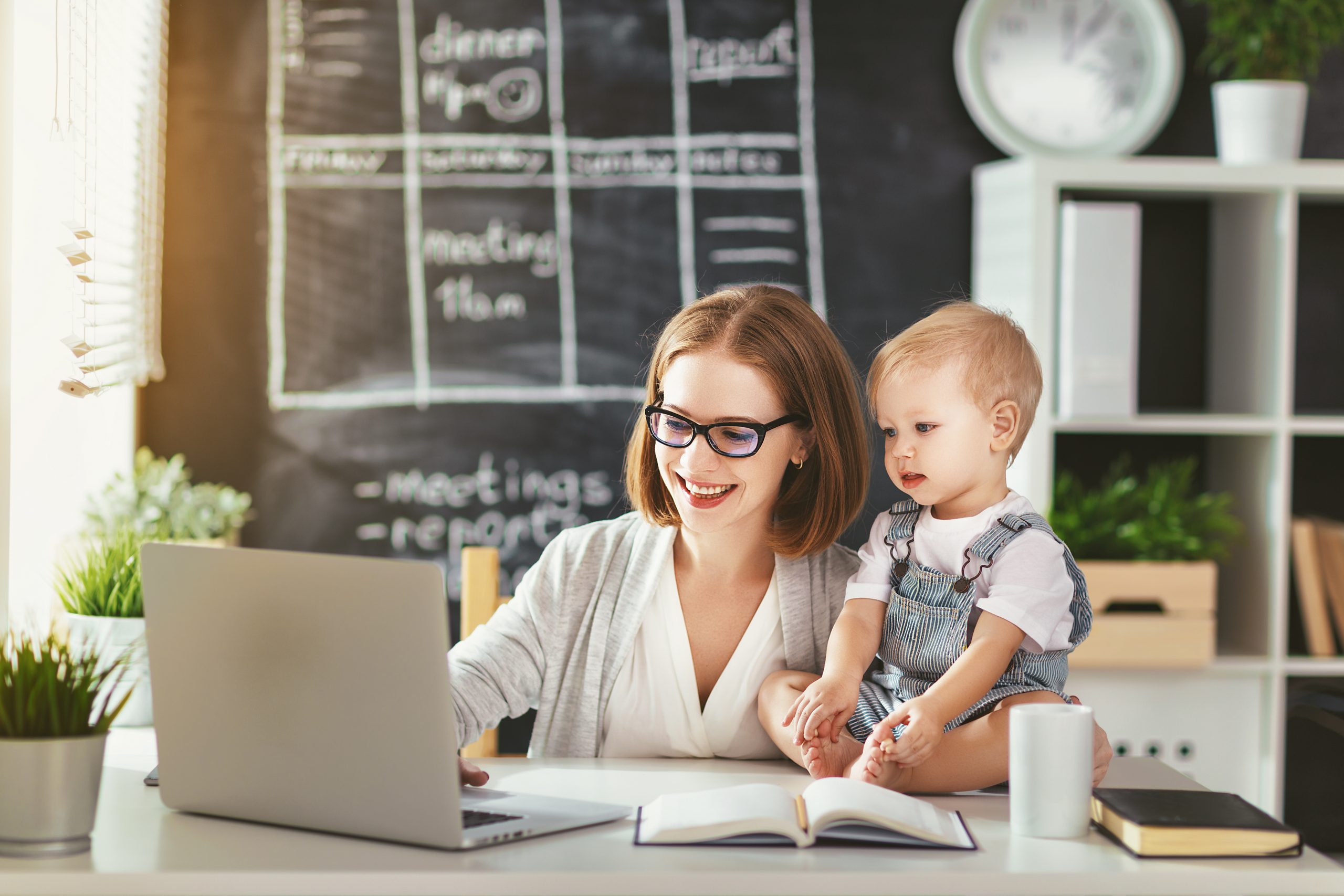 Businesswoman,Mother,Woman,With,A,Toddler,Working,At,The,Computer