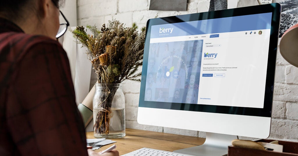 Female employee looking at screen for employee anniversary recognition