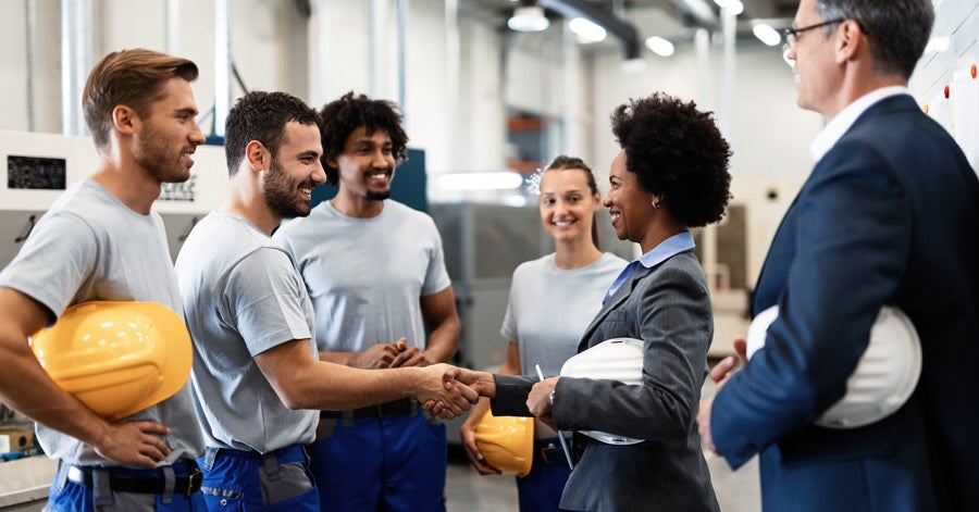 Factory Workers Shaking Hands with Executives