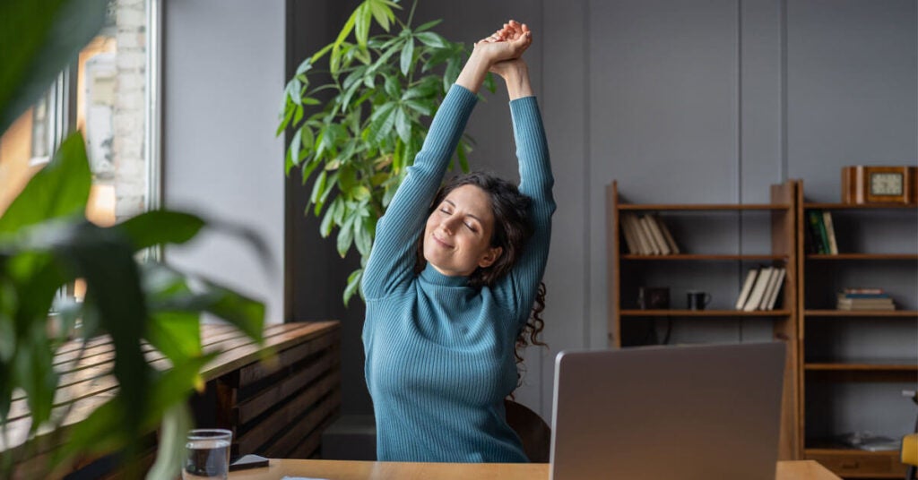 Woman Stretching at her Desk