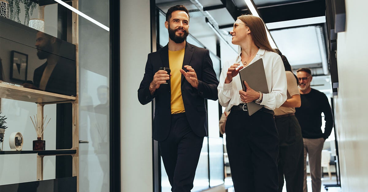 Employees-walking-and-talking-about-employee-wellness-idea