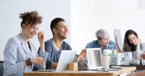 Group of happy employees at big table