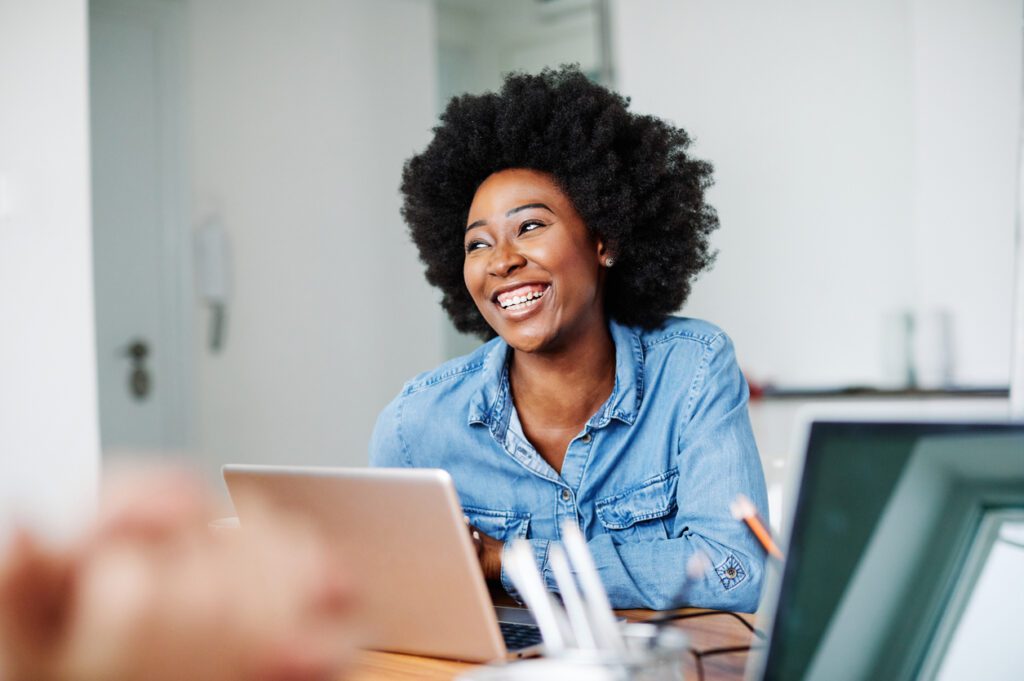 portrait young african american girl woman smiling office classroom Attractive african american business woman in a modern office or a student in a classroom