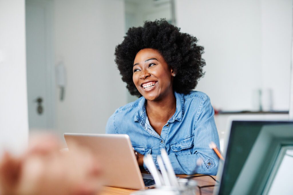 Attractive african american business woman in a modern office or a student in a classroom