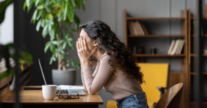 Employee disengaged at desk with laptop