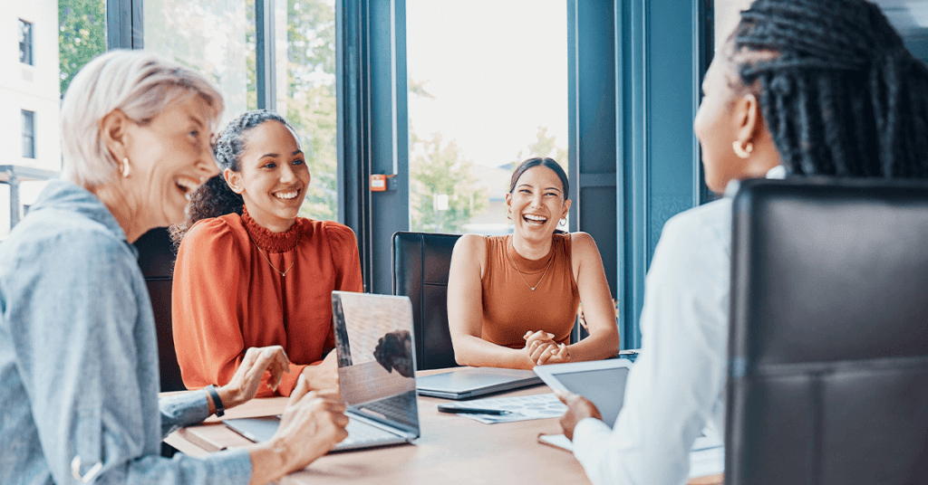 happy employees working at a conference table