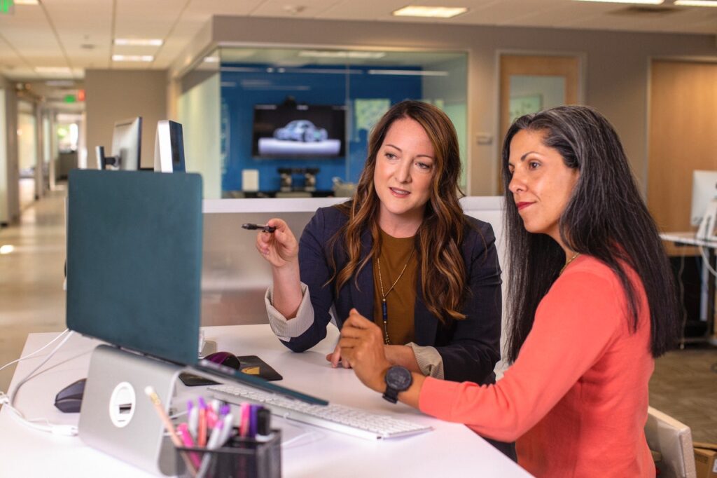 employees looking at a laptop together