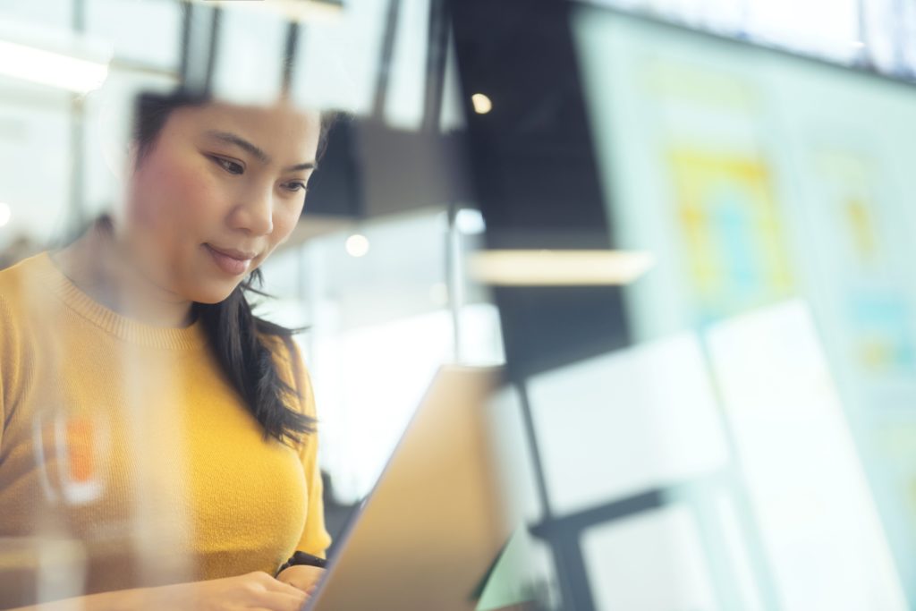 employee looking at her laptop