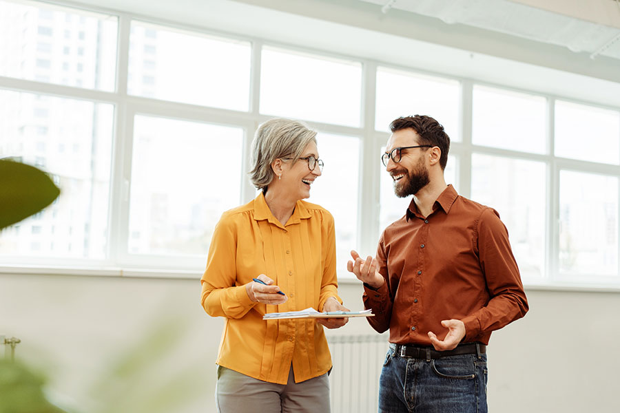 Two colleagues share a friendly chat