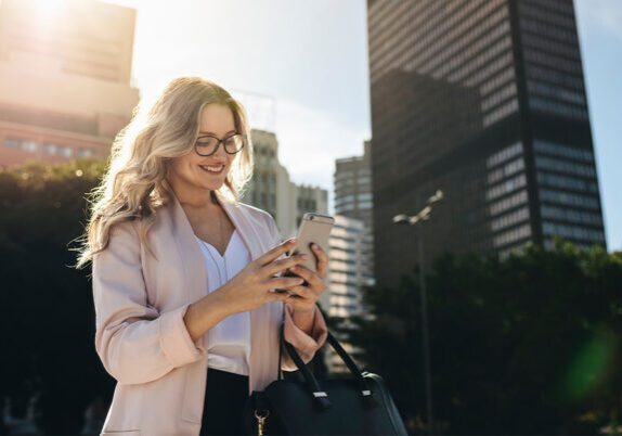 empowered employee checking phone while walking