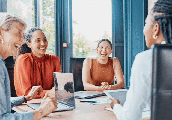 happy employees working at a conference table
