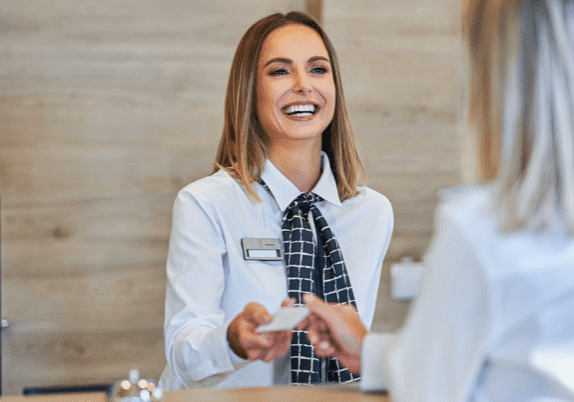 happy woman working at hotel front desk