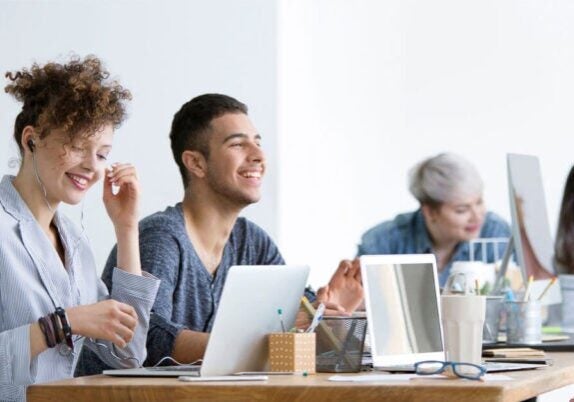 Group of happy employees at big table